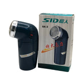 Electric Fabric Shaver with silver top next to its packaging box on a white background